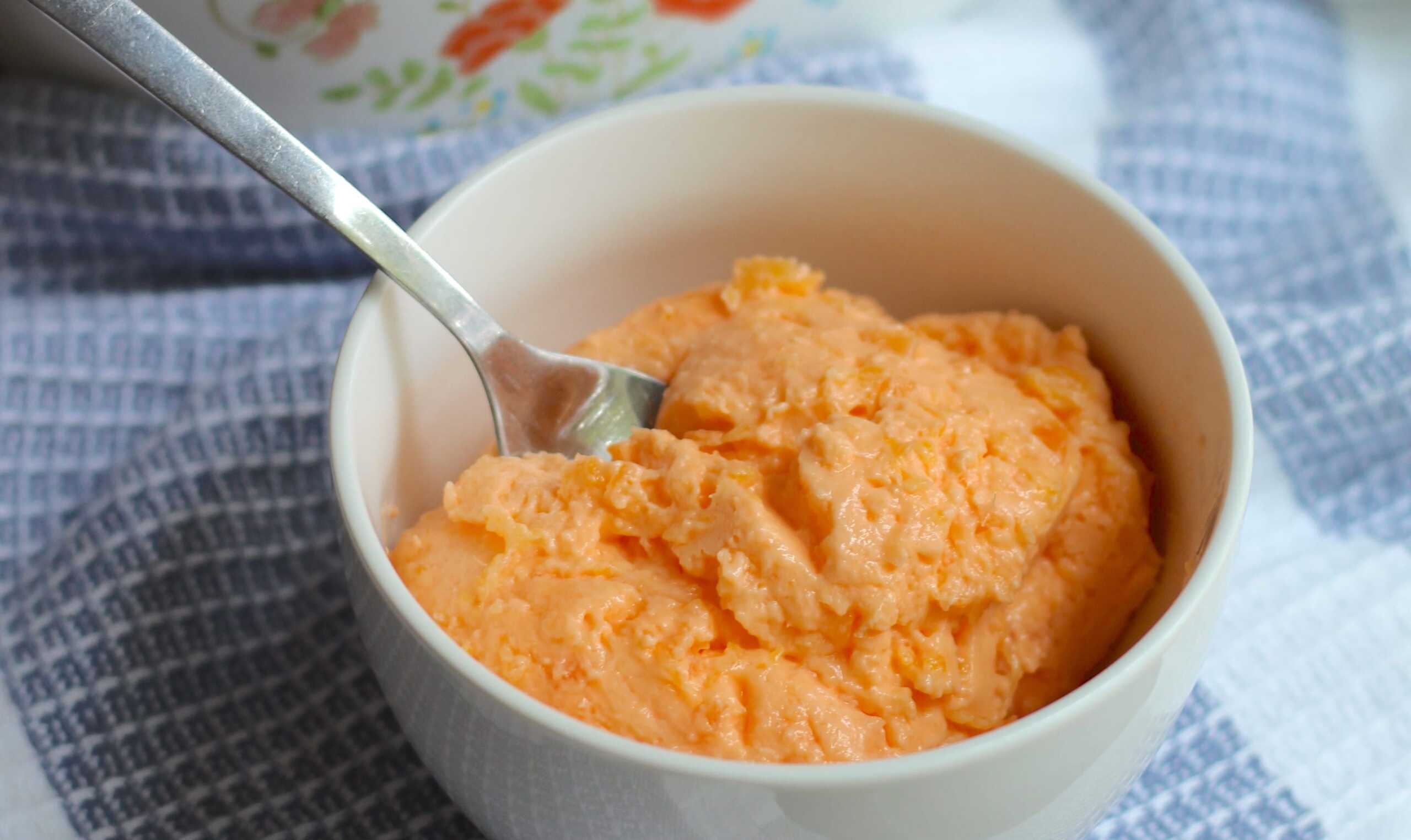 A bowl of orange food.