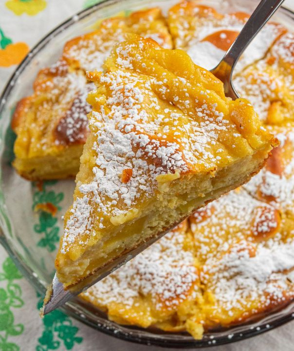 A slice of cake with powdered sugar on it.