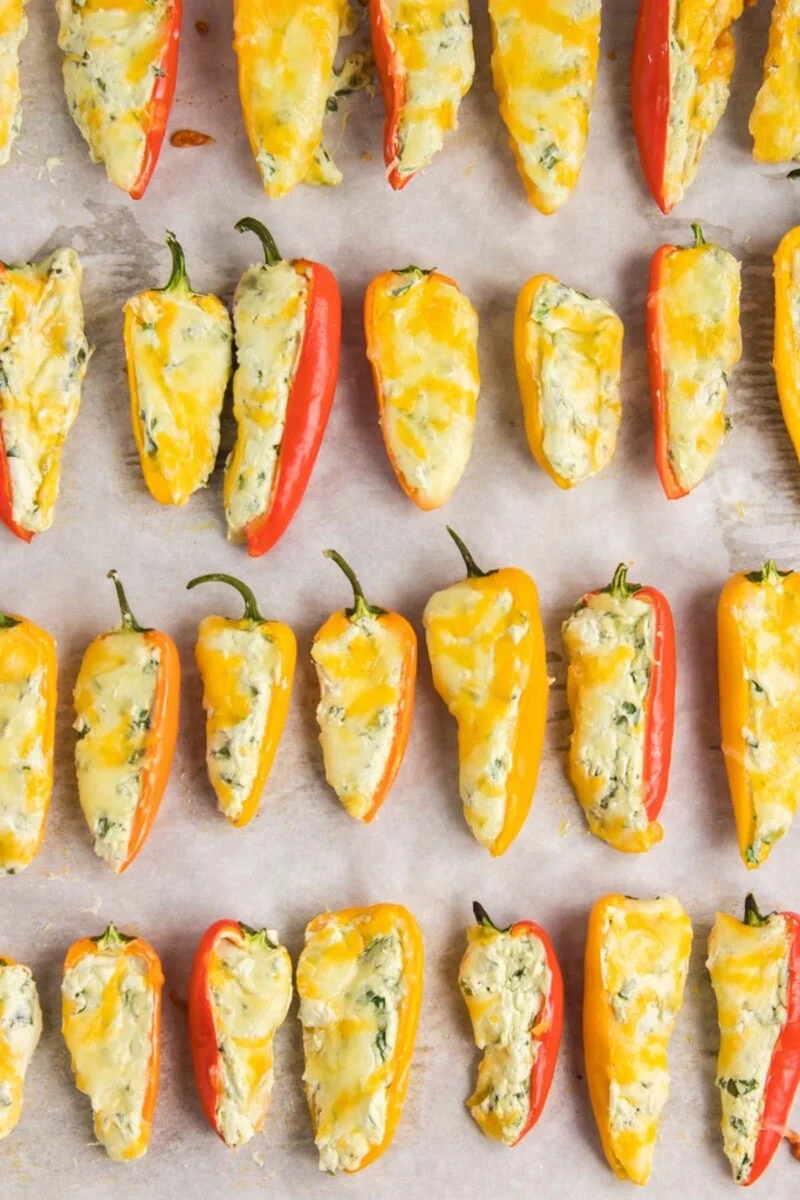 A tray of food with yellow and red peppers.