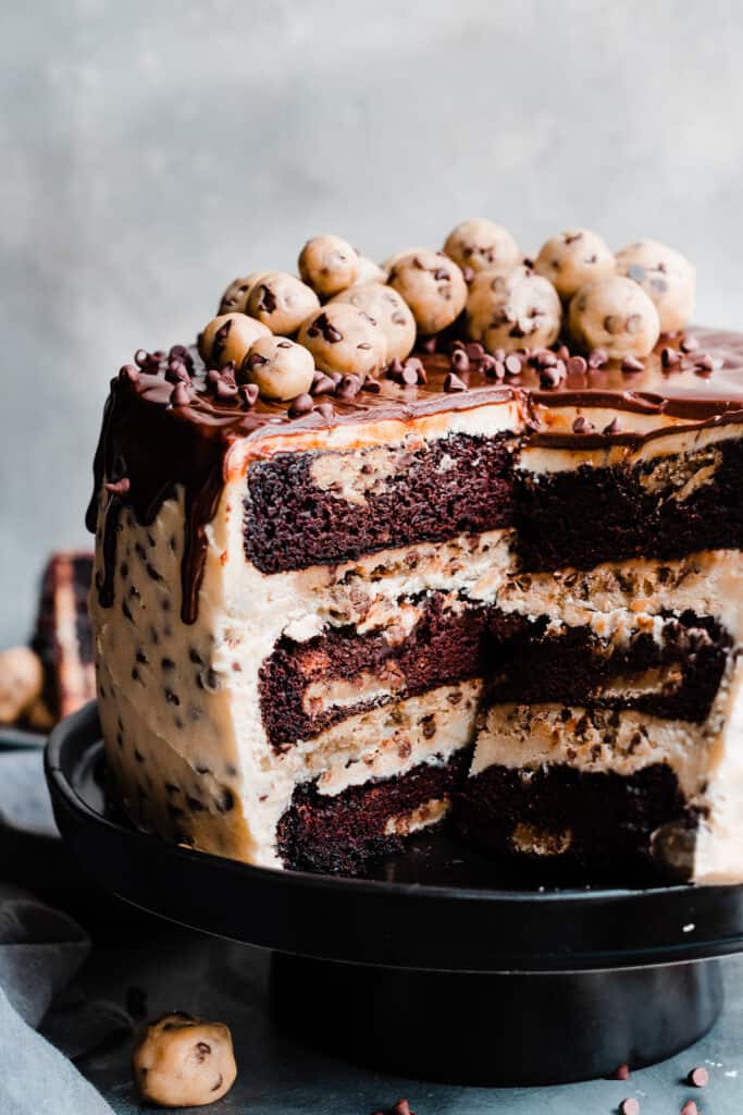 A slice of chocolate cake with chocolate chips on top.