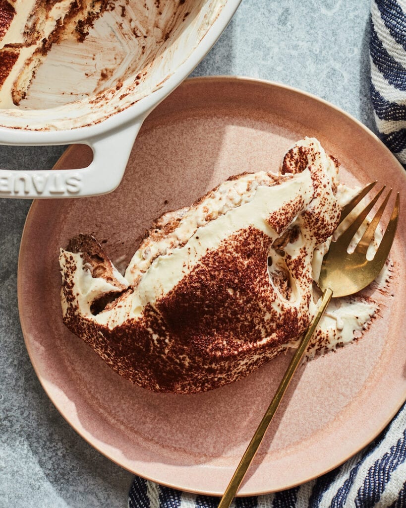 A plate with a fork and a piece of cake.