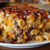 A plate of food with a cheese and meat casserole.