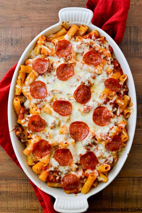 A white bowl filled with pasta and pepperoni.