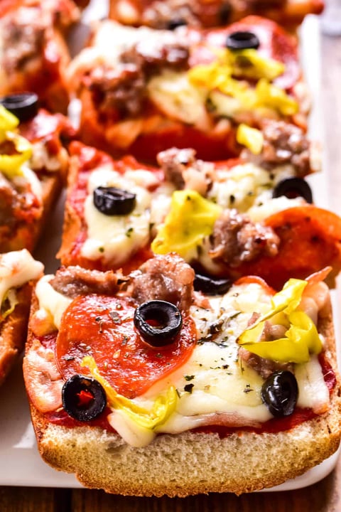 A slice of pizza with olives and cheese.